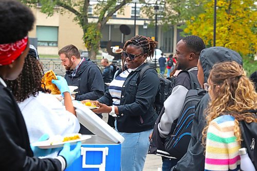 Members of the Brandon University community enjoy a free meal at Kavanagh Courtyard on Friday afternoon during the school’s inaugural langar event. (Kyle Darbyson/The Brandon Sun)