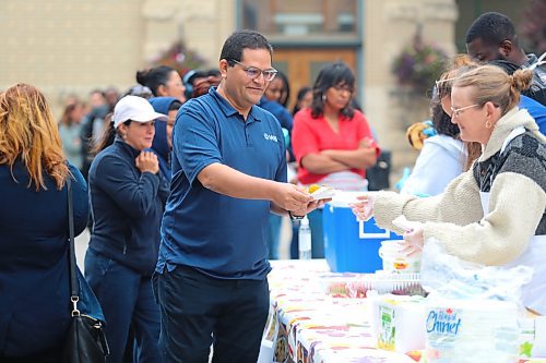 Members of the Brandon University community, and some visitors, enjoy a free meal at Kavanagh Courtyard on Friday afternoon during the school’s inaugural langar event. (Kyle Darbyson/The Brandon Sun)