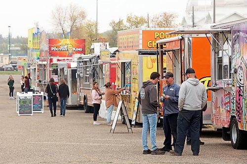 15092023
Visitors check out their lunch options during the opening day of Food Truck Warz 2023 at the Keystone Centre grounds on Friday. The food truck event and midway run until Sunday.
(Tim Smith/The Brandon Sun)