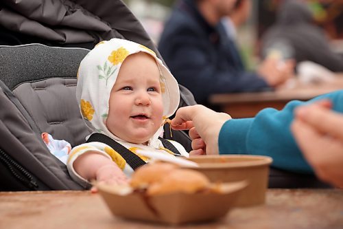 15092023
Seven-month-old Malia Murkin smiles while enjoying lunch with her parents Kole and Brittany during the opening day of Food Truck Warz 2023 at the Keystone Centre grounds on Friday. The food truck event and midway run until Sunday.
(Tim Smith/The Brandon Sun)