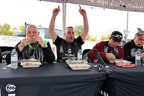 Local personal trainer Rene Lariviere raises his arms in victory during Westman Communication Group’s first-ever Celebrity Hot Wings Challenge, which took place at the Keystone Centre grounds on Saturday during Food Truck Warz. Lariviere bested six other opponents in this contest by devouring 10 spicy chicken wings, measuring 750,000 on the Scoville scale, in under a minute. (Kyle Darbyson/The Brandon Sun) 
