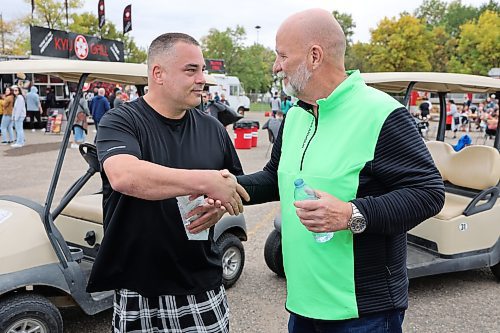 Rene Lariviere shakes hands with Westman Communication Group president and CEO Bud Keys after winning Saturday’s hot wing eating contest that was put together by the service provider. Lariviere won two $50 Visa gift cards for his efforts. (Kyle Darbyson/The Brandon Sun)