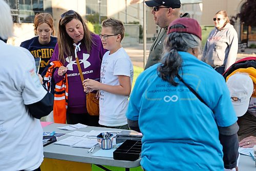 Max Wronowski registers for Sunday’s Terry Fox Run alongside members of his family. Wronowski managed to generate around $1,100 for this year’s event, falling in line with his fundraising efforts for the 2022 Terry Fox Run. (Kyle Darbyson/The Brandon Sun)    