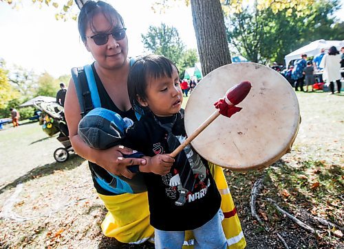 JOHN WOODS / WINNIPEG FREE PRESS
Martha Paul, carrying her daughter Valentina, 3 months, looks on as her son Nash, 1.5 years, plays his drum at the We Are Treaty People celebration event at the Forks in Winnipeg Sunday, September 17, 2023. 

Reporter: ?