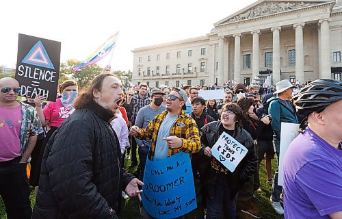 MIKE DEAL / WINNIPEG FREE PRESS
Nick Hamilton (with blue sign), a member of the Trans community, and Alex Halipchuk (with &#x201c;Protect Trans Kids&#x201d; sign), a Trans man and member of the Trans community, have a discussion with an Anti-Trans protestor (who refused to provide his name) on the grounds of the Manitoba Legislative building.
Anti-trans protesters and Trans Rights supporters gather at the Manitoba Legislative building Wednesday morning.
230920 - Wednesday, September 20, 2023.