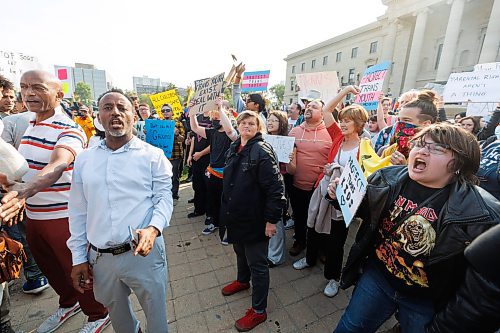 MIKE DEAL / WINNIPEG FREE PRESS
Trans Rights supporters (right) and Anti-trans protesters (left) shout at each other on the grounds of the Manitoba Legislative building Wednesday morning.
230920 - Wednesday, September 20, 2023.