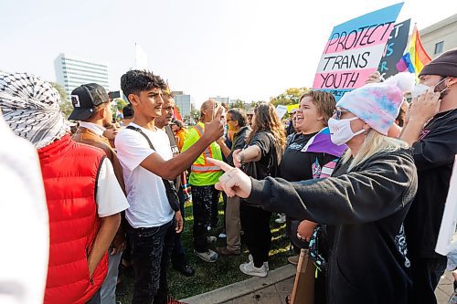 MIKE DEAL / WINNIPEG FREE PRESS
Trans Rights supporters (right) and Anti-trans protesters (left) shout at each other on the grounds of the Manitoba Legislative building Wednesday morning.
230920 - Wednesday, September 20, 2023.