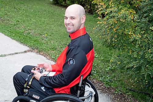 BROOK JONES / WINNIPEG FREE PRESS
Twenty-nine-year-old Lealand Muller, who represented Canada at the 2023 Invictus Games in D&#xfc;sseldorf, Germany from Sept. 9 to 16, is all smiles as he holds various pins he collected at the game. Muller is pictured in his front yard at his home in Winnipeg, Man., Thursday, Sept. 21, 2023 and competed in hand cycle, discuss and wheelchair basketball. Canada will play host to the 2025 Invictus Game in Vancouver and Whistler. 