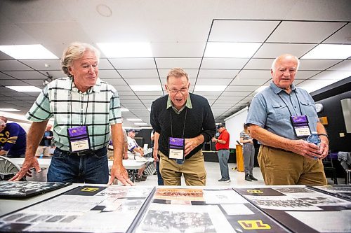 MIKAELA MACKENZIE / WINNIPEG FREE PRESS

Ex-Panther football players Clary Makinson (left), Wayne Hawrysh, and Bob Wilkes look at old photos and clippings at a reunion for the 50th anniversary of the 1973 championship game where they captured the Winnipeg High School Football League title at Gordon Bell High School on Thursday, Sept. 21, 2023. For Sawatzky story.
Winnipeg Free Press 2023