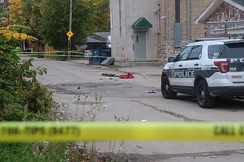 Police responded to a serious incident in the 500 block of Furby Street Saturday, Sept. 23, 2023. A large section of the alleyway between Furby and McMicken streets was cordoned, with the remains of what appeared to be emergency medical gear scattered on the pavement. (Tyler Searle / Winnipeg Free Press)