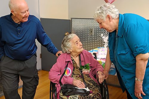 Eileen Harris chats with her son Ray and daughter Lynne during her 105th birthday celebration at the East End Community Centre in Brandon. (Kyle Darbyson/The Brandon Sun)