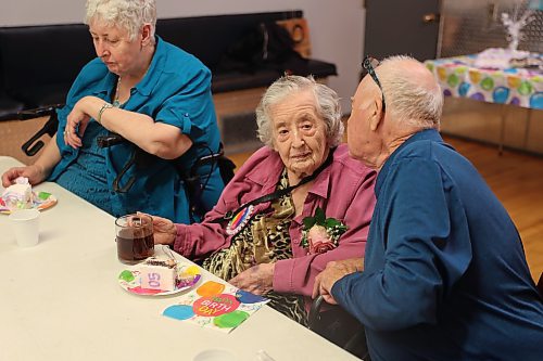 Eileen Harris enjoys some birthday cake alongside her son Ray and daughter Lynne at the East End Community Centre on Sunday. Harris officially turned 105 on Saturday. (Kyle Darbyson/The Brandon Sun)