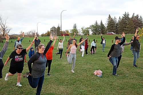 25092023
Brandonites stretch while learning Bhangra dance from Sikh-Canadian performer, author and social-media celebrity Gurdeep Pandher at Dinsdale Park on Monday evening. Pandher's videos of himself performing the Bhangra dance on a frozen lake in the Yukon, where he lives, went viral during the COVID-19 pandemic. He is currently touring across Canada to share his message and love of dance. (Tim Smith/The Brandon Sun)
