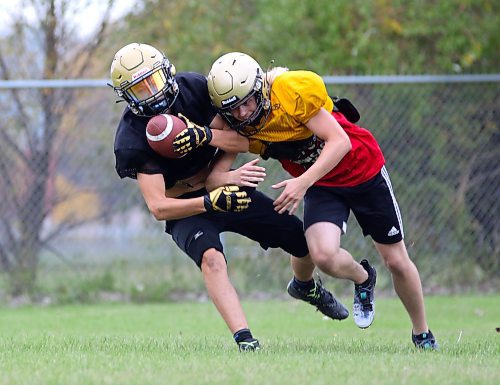Daniel Nevin, left, picks off a pass intended for Cole Klassen during Crocus Plainsmen football practice on Tuesday. Nevin was named WHSFL South West Division defensive player of the week after a win in Week 2. (Thomas Friesen/The Brandon Sun)