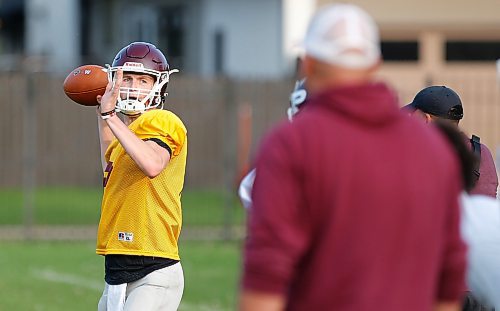JOHN WOODS / WINNIPEG FREE PRESS
St Paul’s quarterback Cole Anseeuw throws as quarterback coach Shane Munson looks on during practice at St Paul’s High School in Winnipeg Tuesday, September 26, 2023. 

Reporter: josh