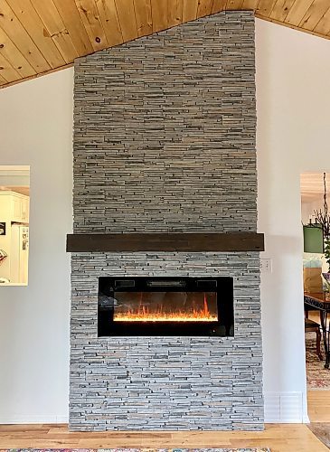 Photos by Marc LaBossiere / Winnipeg Free Press
The main structure of the feature wall is decoratively sheathed in faux stone, with a girthy rustic mantle set shoulder-high above the electric inset fireplace unit