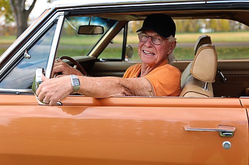 Lynn Flewitt in his 1969 Dodge Dart Swinger two-door hard-top at a park west of Brandon on Thursday. (Michele McDougall/The Brandon Sun)