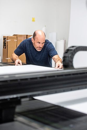 MIKAELA MACKENZIE / WINNIPEG FREE PRESS

Don Gaye, owner of The Sign Source, lines material up on the flatbed printer to demonstrating election sign printing in his shop on Thursday, Sept. 28, 2023. For Maggie story.
Winnipeg Free Press 2023.