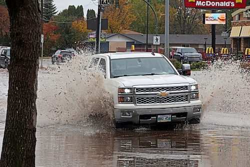 28092023
Vehicles drive through deep water flooding Richmond Avenue west of 18th Street after a thunderstorm and downpour on Thursday morning. 
(Tim Smith/The Brandon Sun)