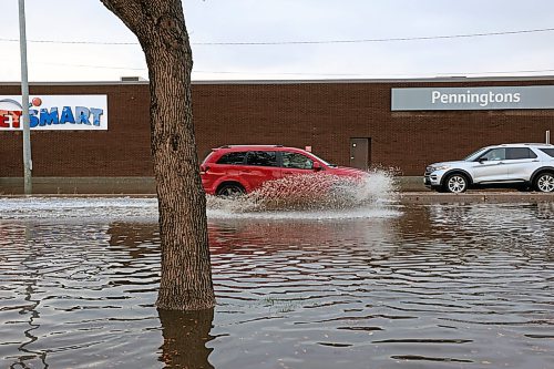 28092023
Vehicles drive through deep water flooding Richmond Avenue west of 18th Street after a thunderstorm and downpour on Thursday morning. 
(Tim Smith/The Brandon Sun)