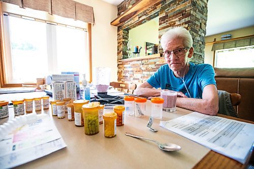 MIKAELA MACKENZIE / WINNIPEG FREE PRESS

Rick Schmidt at his kitchen table (with various medicines, charts, and equipment) while recovering from a lung transplant on Thursday, July 27, 2023. For John Longhurst story.
Winnipeg Free Press 2023