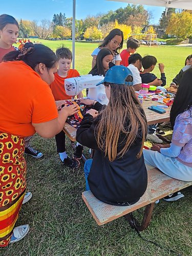 Middle school students learn how to sew a ribbon skirt as part of Indigenous Culture Day in Neepawa on Friday. (Miranda Leybourne/The Brandon Sun)