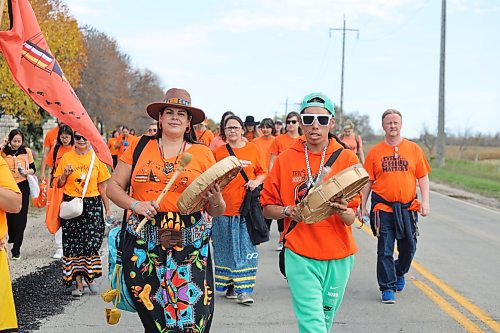 Indigenous drummers Joy Hamilton-Flaman and Sam Jackson walk down Wokiksuye Ċanku (Remembrance Road) towards the site of the old Brandon Indian Residential School during Orange Shirt Day. (Kyle Darbyson/The Brandon Sun)