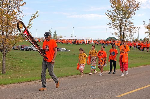 Birdtail Sioux First Nation member Fred Wood, left, leads Brandon’s Orange Shirt Day Walk participants away from the Riverbank Discovery Centre grounds and towards the site of the old Brandon Indian Residential School. (Kyle Darbyson/The Brandon Sun)