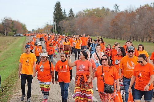 Hundreds of people march down Wokiksuye Ċanku (Remembrance Road) during Brandon’s Orange Shirt Day festivities. The crowd’s final destination was the site of the old Brandon Indian Residential School, which was founded in 1895 and ceased operations in 1972. (Kyle Darbyson/The Brandon Sun)