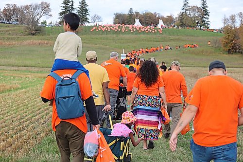 Brandon’s Orange Shirt Day participants climb a hill towards the site of the old Brandon Indian Residential School. The 104 orange hearts that decorate the hill symbolize the unmarked graves that Sioux Valley Dakota Nation members believe are located at this site. (Kyle Darbyson/The Brandon Sun)