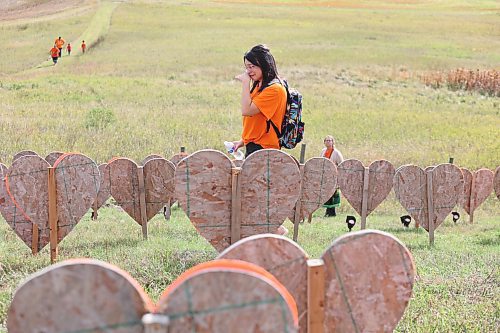 Desjaray Saulteaux weeps at the sight of the 104 hearts that are planted near Brandon Indian Residential School during Orange Shirt Day. These orange hearts represent the 104 unmarked graves that members of Sioux Valley Dakota Nation believe are located at this site. Saulteaux, who is from Carry the Kettle Nakoda Nation in Saskatchewan, told the Sun that her dad attended a residential school but doesn’t like to talk about it. (Kyle Darbyson/The Brandon Sun)