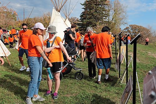 Brandon’s Orange Shirt Day participants check out the historical photos and artefacts on display at the Brandon Indian Residential School site over the weekend. The school operated between 1895 and 1972 and was finally demolished in 2006. (Kyle Darbyson/The Brandon Sun)