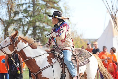 A member of the Sioux Valley Dakota Nation Unity Riders arrives at the Brandon Indian Residential School site on Orange Shirt Day to commemorate the Indigenous children who never returned home from this institution. (Kyle Darbyson/The Brandon Sun)