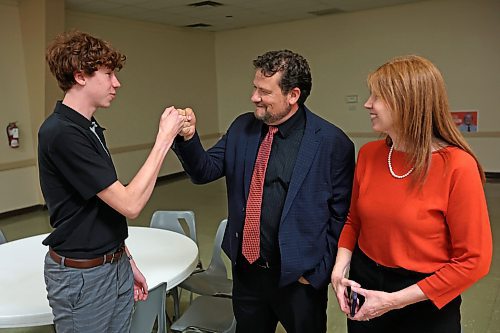 03102023
Brandon East NDP candidate Glen Simard bumps fists with his son Nathan while alongside his wife Lori at the Brandon NDP campaign party at the Royal Canadian Legion Branch 3 on Victoria Avenue East on Tuesday evening after winning his seat in the Manitoba Legislature. 
(Tim Smith/The Brandon Sun)