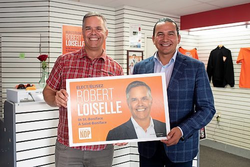 BROOK JONES / WINNIPEG FREE PRESS
Manitoba NDP Party Leader Wab Kinew (right) holds an election sign as he visits NDP candidate for St. Boniface Robert Loiselle on election day in Manitoba at his campaign office in Winnipeg, Man., Tuesday, Oct. 3, 2023. Manitobans are voting in the Manitoba Provincial Election Tuesday, Oct. 3, 2023.