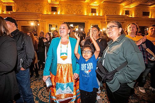 MIKAELA MACKENZIE / WINNIPEG FREE PRESS

Calahoo Stonehouse (left, first First Nations woman MLA, from Edmonton) Isaiah Gladue (seven), and Tanya Kappo cheer as results start coming in at the NDP party headquarters at the Fort Garry Hotel on Tuesday, Oct. 3, 2023. For election story.
Winnipeg Free Press 2023.