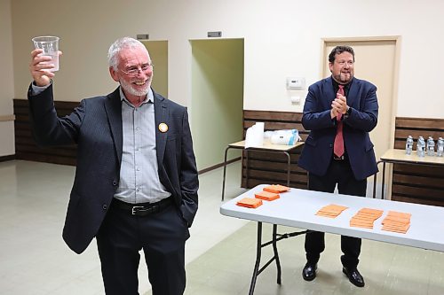 03102023
Brandon West NDP Candidate Quentin Robinson (L) salutes supporters while Brandon East NDP candidate Glen Simard applauds after polls come in showing both candidates in the lead in their ridings during their campaign party at the Royal Canadian Legion Branch 3 on Victoria Avenue East on Tuesday evening. 
(Tim Smith/The Brandon Sun)