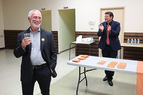 03102023
Brandon West NDP Candidate Quentin Robinson (L) salutes supporters while Brandon East NDP candidate Glen Simard applauds after polls come in showing both candidates in the lead in their ridings during their campaign party at the Royal Canadian Legion Branch 3 on Victoria Avenue East on Tuesday evening. 
(Tim Smith/The Brandon Sun)