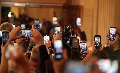 JASON HALSTEAD / WINNIPEG FREE PRESS
NDP hold up phones and cameras as leader Wab Kinew approaches the stage on Oct. 3, 2023 at the Fort Garry Hotel.