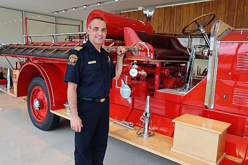 Marc Lefebvre, Deputy Fire Chief with Brandon Fire and Emergency Services stands next to the 1929 Bickle fire truck, in the museum at Brandon’s No. 1 Fire Hall, 120 19th Street North, on Thursday. (Michele McDougall/The Brandon Sun)
