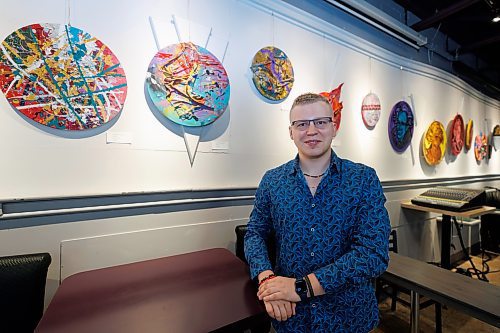 MIKE DEAL / WINNIPEG FREE PRESS
Artist Cole Cancilla with his distinctive canvases that are on display in Xcues caf&#xe9; and lounge at 551 Sargent Avenue.
Artist Cole Concilla&#x2019;s 20 round canvases are a peek into his mind. Covering a whole range of styles from figurative to abstract via textural textile work and spray paint Concilla says this body of work shows his versatility as an artist by pushing the challenges of pluralism. 
231005 - Thursday, October 05, 2023.
