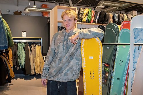 BROOK JONES / WINNIPEG FREE PRESS
Fane Smeall, who owns Sk8 Skates with his family, stands next to a number of snowboards, while working at the local shop at 564 Main Street in Winnipeg, Man., Thursday, Oct. 6, 2023. Sk8 Skates is having a 40 per cent off sale called Last Season Snow. The 23-year-old fears the business might close because sales have dropped off during the past year and attributes it to a higher cost of living for people.