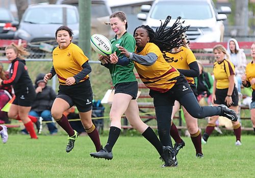 Ashley Korney of the Dauphin Clippers has the ball knocked away from her from behind by Rebecca Alebiosu of Crocus Plains as Amber Neapew looks on during the varsity girls rugby 7s provincial championship at John Reilly Field. (Perry Bergson/The Brandon Sun)