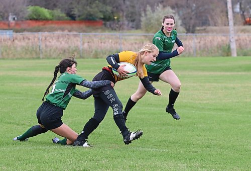 Faith Burtnick of the Crocus Plainsmen breaks through a tackle by Samantha Gryba of the Dauphin Clippers and prepares to square off against Ashley Korney as she scores a try to put her team up 20-19 late in the varsity girls rugby 7s provincial championship final at John Reilly Field. (Perry Bergson/The Brandon Sun)