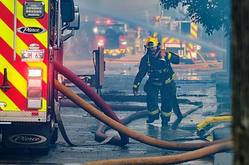 MIKE DEAL / WINNIPEG FREE PRESS
WFPS crews try to douse a large fire in the block on the southwest corner of Sutherland Avenue and Maple Street North Tuesday morning. 
230704 - Tuesday, July 04, 2023.