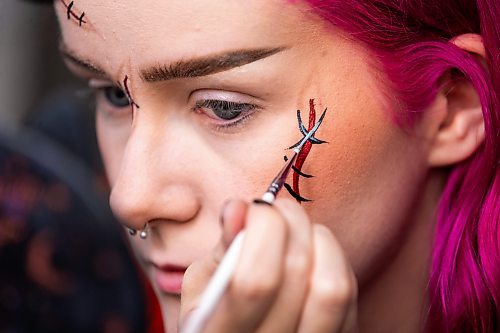 MIKAELA MACKENZIE / WINNIPEG FREE PRESS

Maddy Harms demonstrates how to add grey highlights to stitch lines for a faux stitches Halloween make-up look on Wednesday, Oct. 11, 2023. For AV Kitching story.
Winnipeg Free Press 2023.