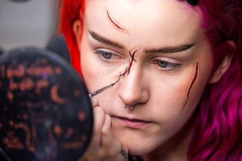 MIKAELA MACKENZIE / WINNIPEG FREE PRESS

Maddy Harms demonstrates how to add black stitch lines for a faux stitches Halloween make-up look on Wednesday, Oct. 11, 2023. For AV Kitching story.
Winnipeg Free Press 2023.