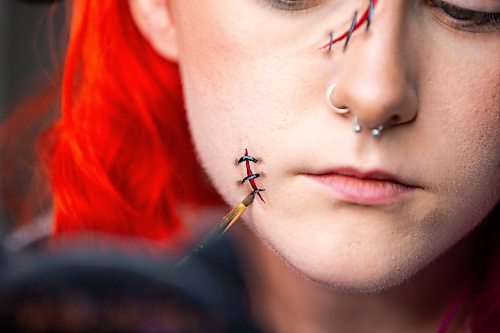 MIKAELA MACKENZIE / WINNIPEG FREE PRESS

Maddy Harms demonstrates how to add shading at the end of each stitch line for a faux stitches Halloween make-up look on Wednesday, Oct. 11, 2023. For AV Kitching story.
Winnipeg Free Press 2023.