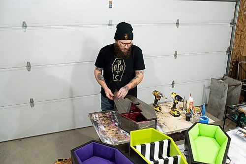 BROOK JONES / WINNIPEG FREE PRESS
Blake Locken, who works as a carpenter by day, runs a home-based business called Old Pine Box Curiousitiies. Locken is pictured working on a coffin shaped cabinet in his garage, which dubs as his workshop, in Winnipeg, Man., Wednesday, Oct. 11 . He also builds upholstered pet beds and charcuterie boards, all with a coffin shape theme. The Winnipeg resident will be a vendor at the Punk Rock Flea Market at the University of Manitoba in Winnipeg, Man., Saturday, Oct. 14, 2023 from 10:30 a.m. to 5 p.m. The event also run Sunday, Oct. 15, 2023.