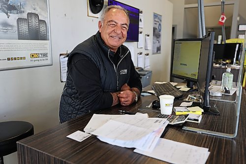 Jake Zorzos,owner and operator of OK Tire in Brandon is all smiles behind the order desk on Thursday. (Michele McDougall/The Brandon Sun)